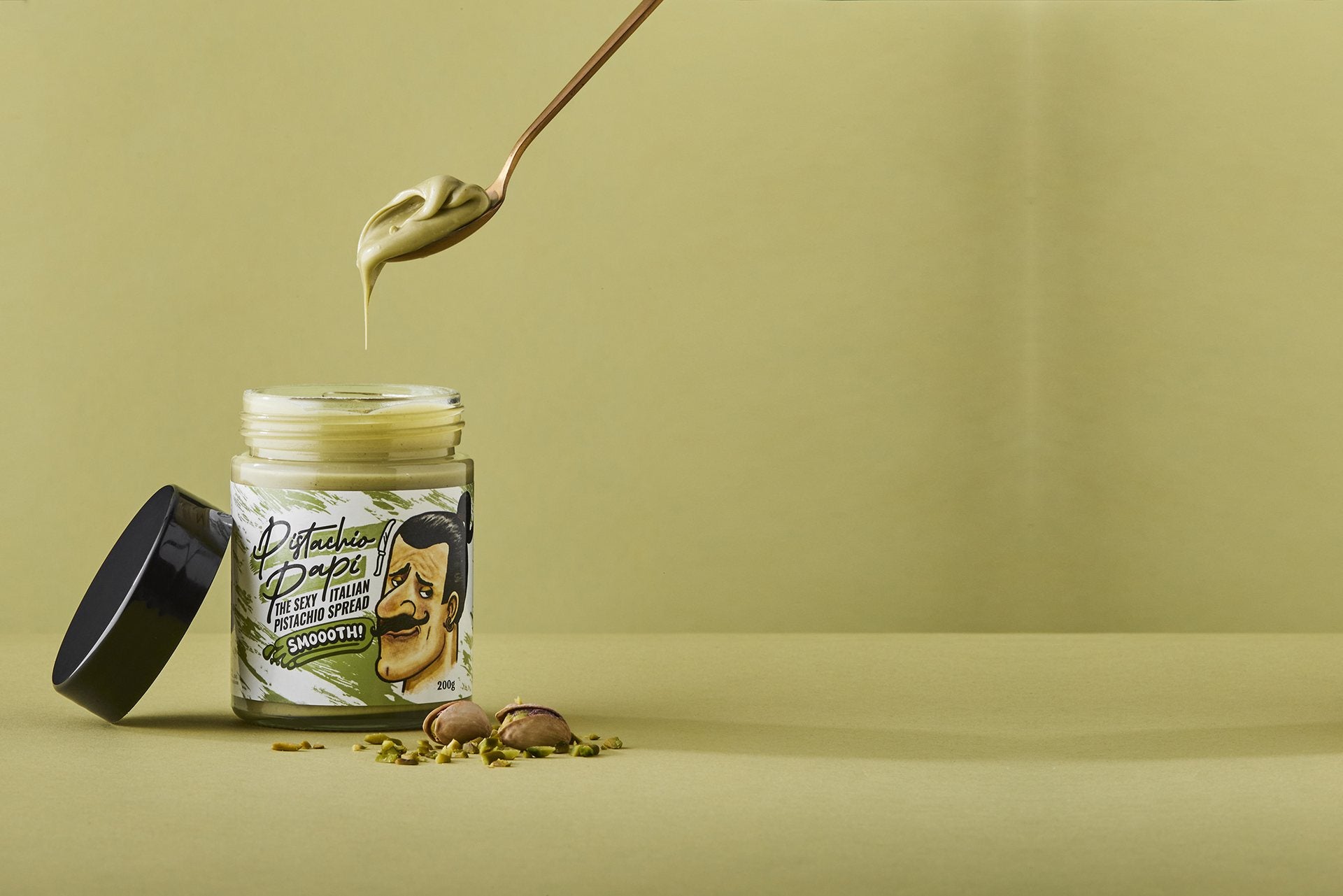 Pistachio Papi Smooth Spread 200g — spoon dipping into the jar